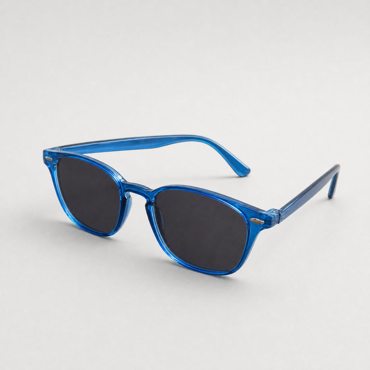 Blue frame sunglasses with dark lenses resting on a wooden table